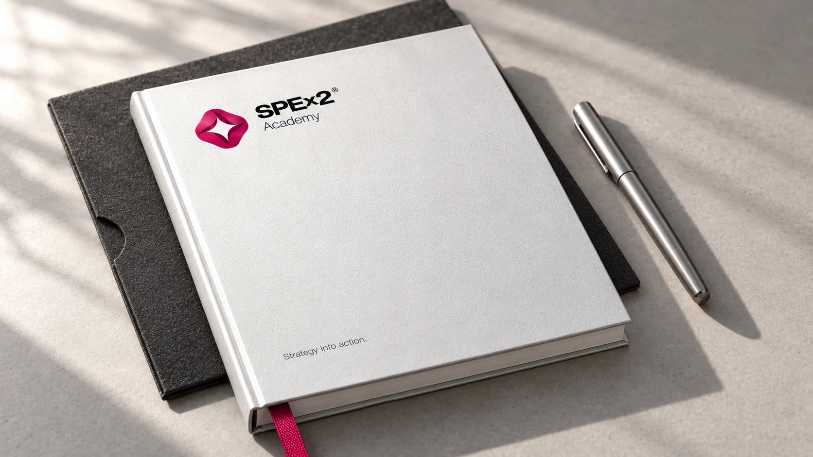SPEx2 Academy notebooks and pen in white, charcoal and raspberry.