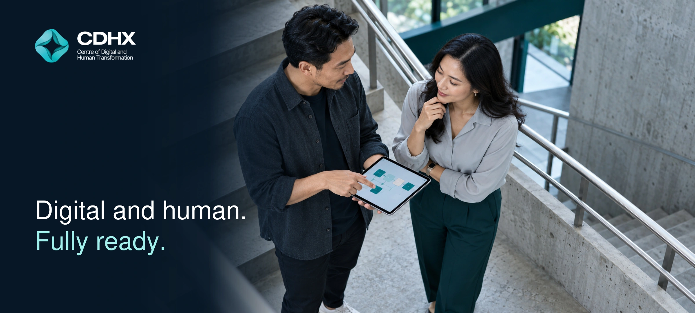 Digital and human. Fully ready. Two professionals discussing a digital workflow on a tablet, seated on an architectural staircase.